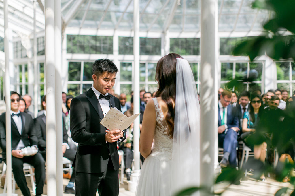 A groom reading his vows to his bride during their wedding ceremony